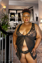Plus size model wearing Audrina plus size lingerie black lace sheer babydoll from CT Lingerie clearance