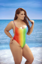 CT Lingerie colorful plus size swimsuit with rainbow gradient design worn by a woman on the beach