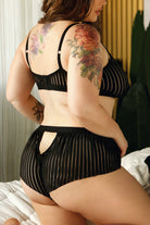 CT Lingerie plus size model wearing sexy striped bralette and panties in sheer black with cutout back
