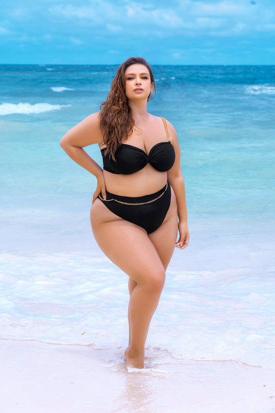 Plus size model wearing CT Lingerie lyra sexy black bikini standing on the beach with ocean background